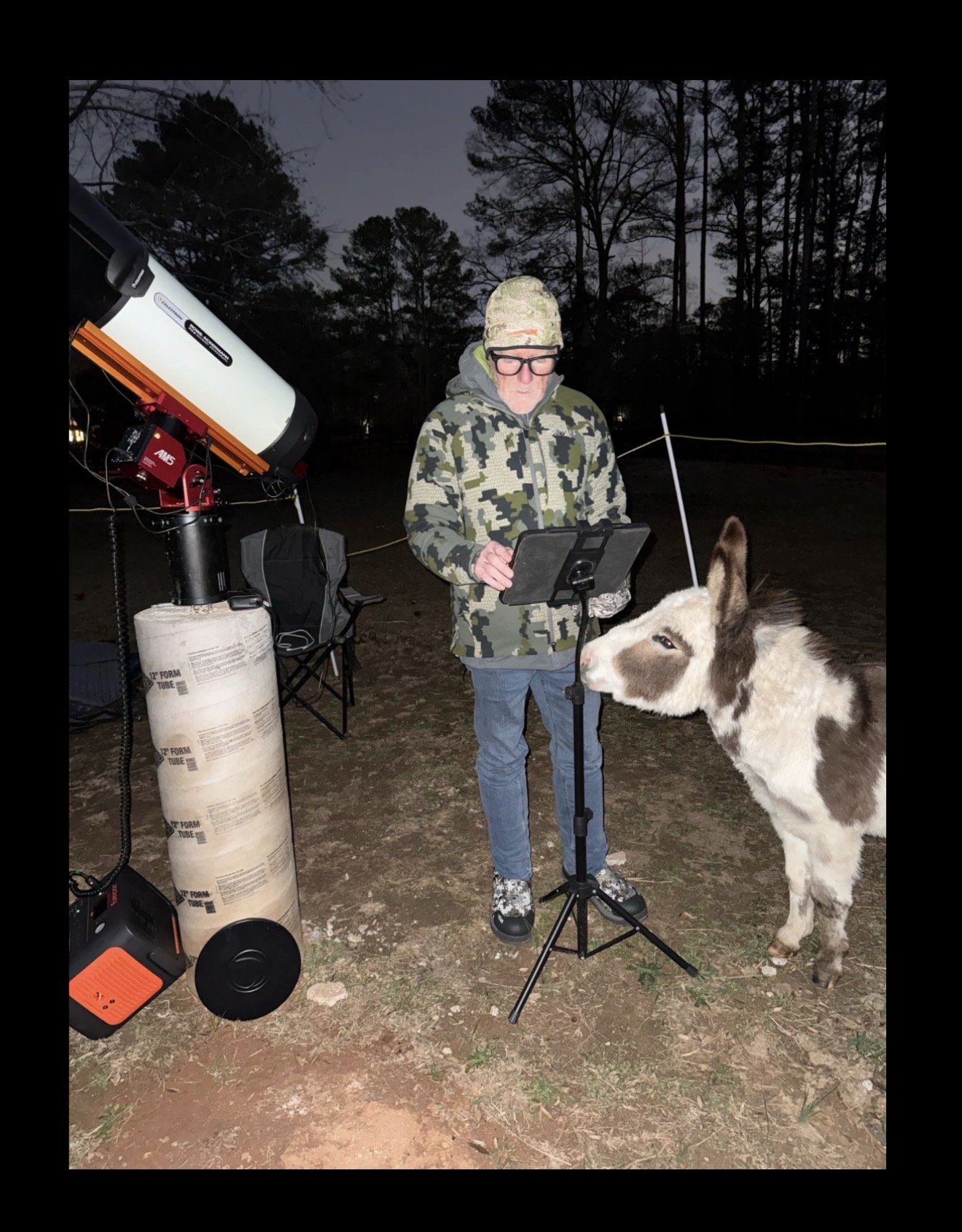Shawn Gurley operating his telescope and tablet at night